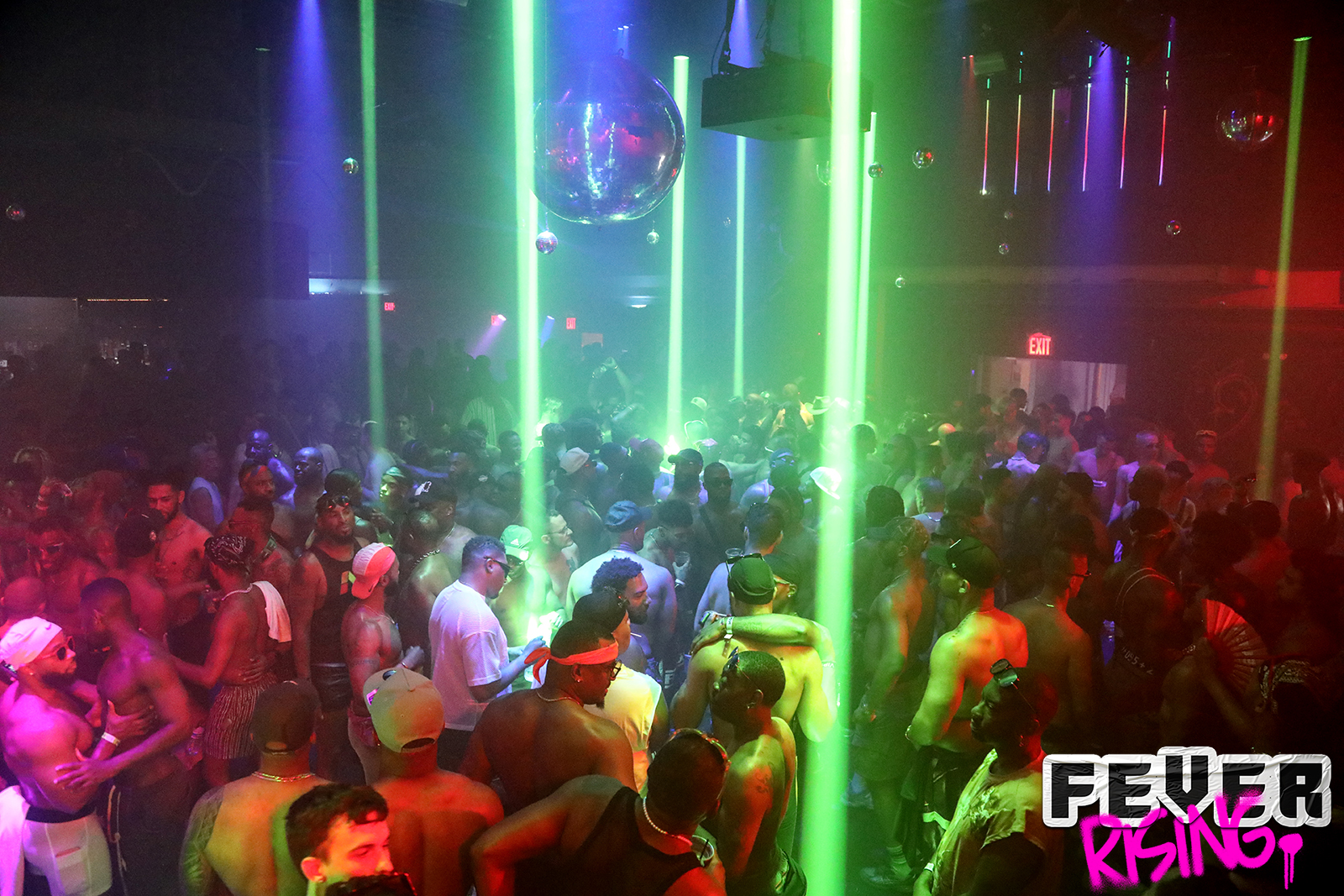 Green laser columns over a crowded main room